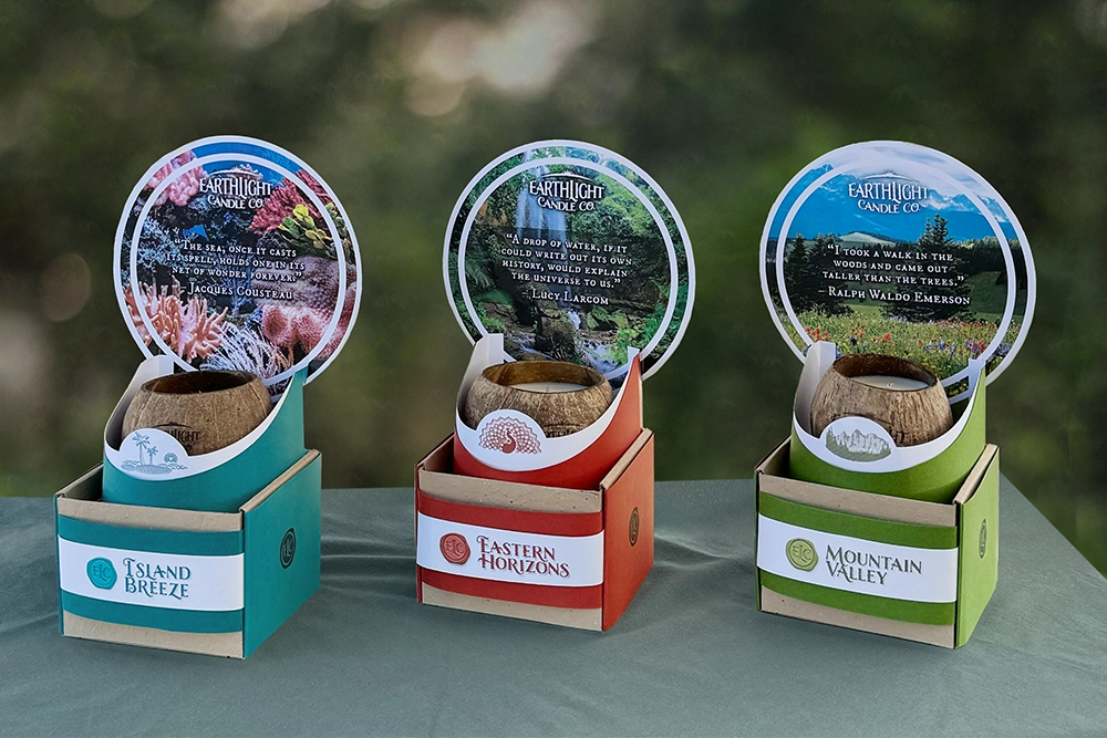 Island Breeze, Eastern Horizons, and Mountain Valley candle packaging